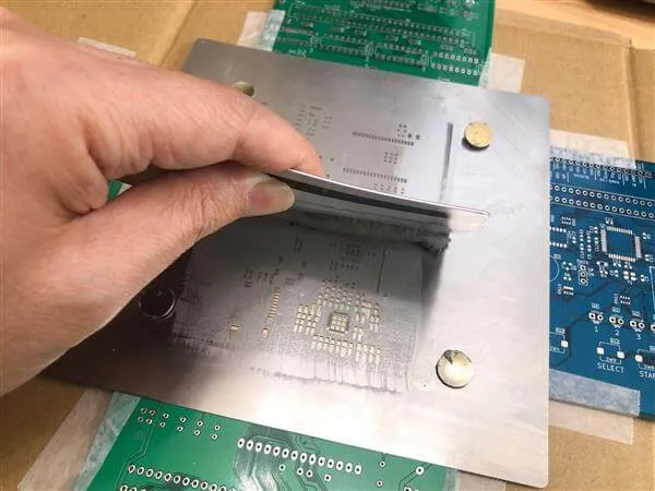 Solder paste printing with stencil on PCB for SMT assembly