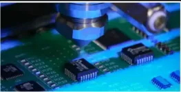 Conformal coating spray application on a PCB for even coverage.