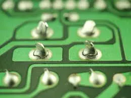 Close-up of SMT assembly with solder joints for continuity testing.