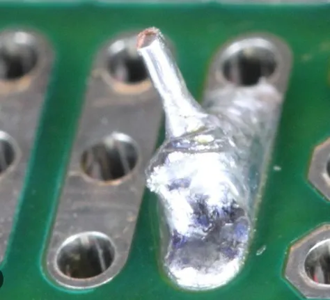 Close-up of shiny lead-free solder joints on audio amplifier PCB