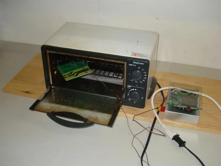 DIY reflow soldering setup using a toaster oven for SMD components.