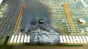 Damaged ATM PCB with burnt components and corrosion for failure analysis