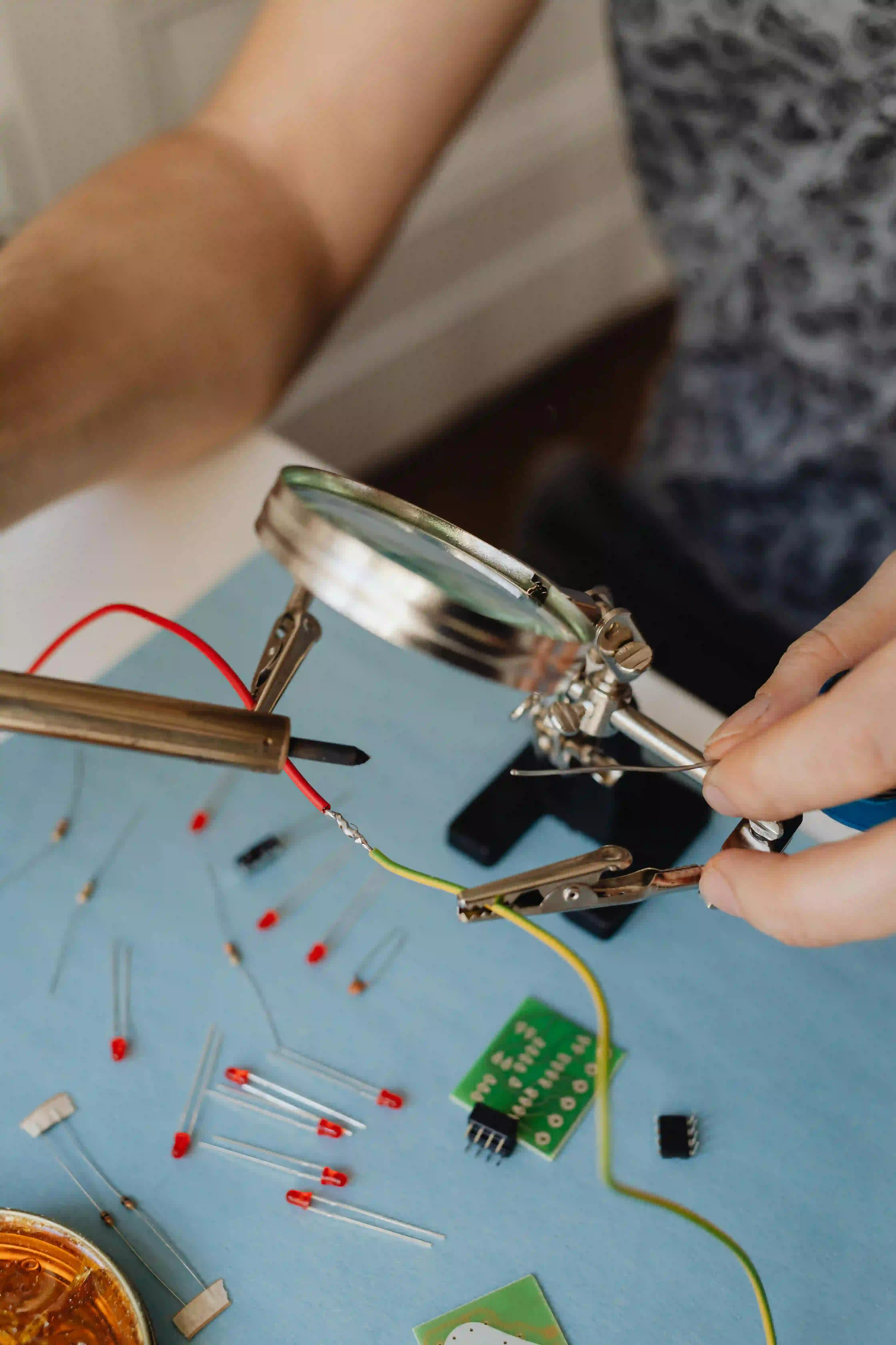 "Hobbyist testing a PCB with budget-friendly diagnostic tools."