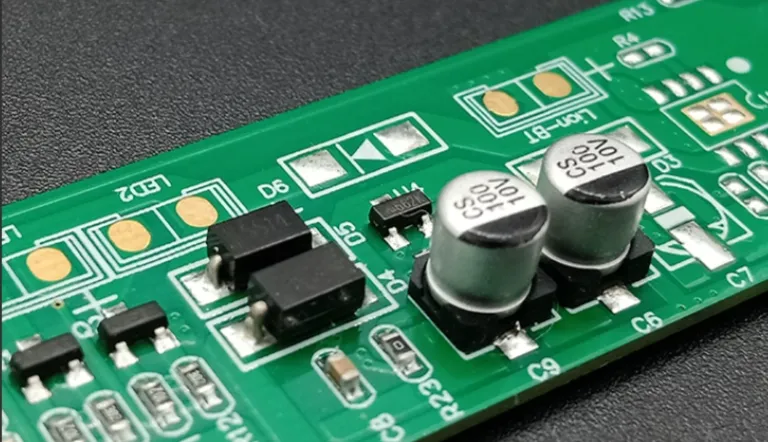 Close-up of through-hole components on a PCB during THT PCBA assembly.