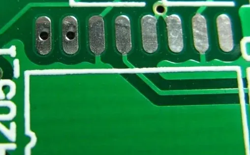Fine-pitch component on PCB with optimized solder mask web.