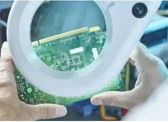 Technician examining FR-4 PCB under microscope for acceptability criteria