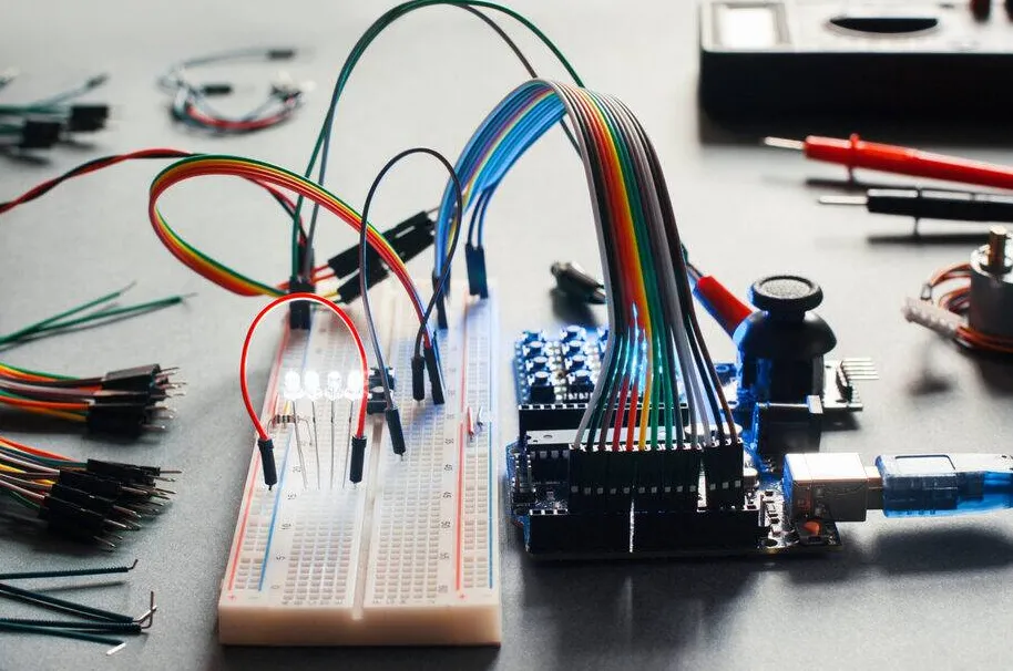 Breadboard PCB prototype assembly with components and jumper wires connected.