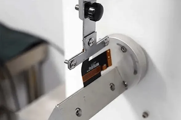 Flexible PCB undergoing bending stress test for design validation.