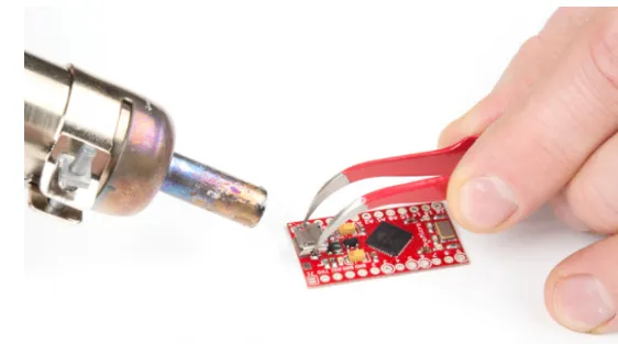 Hot air rework station reflowing new component on solder paste deposits