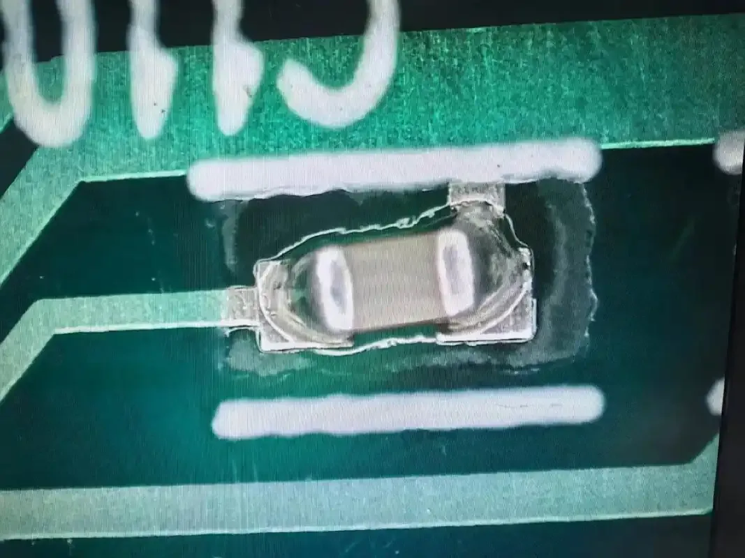 Close-up of a defective PCB with broken traces during mass production
