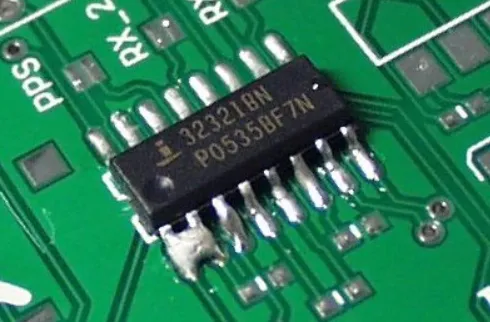 PCB with solder bridging defect after wave soldering."