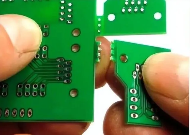 Close-up of perforated breakaway tab on PCB.