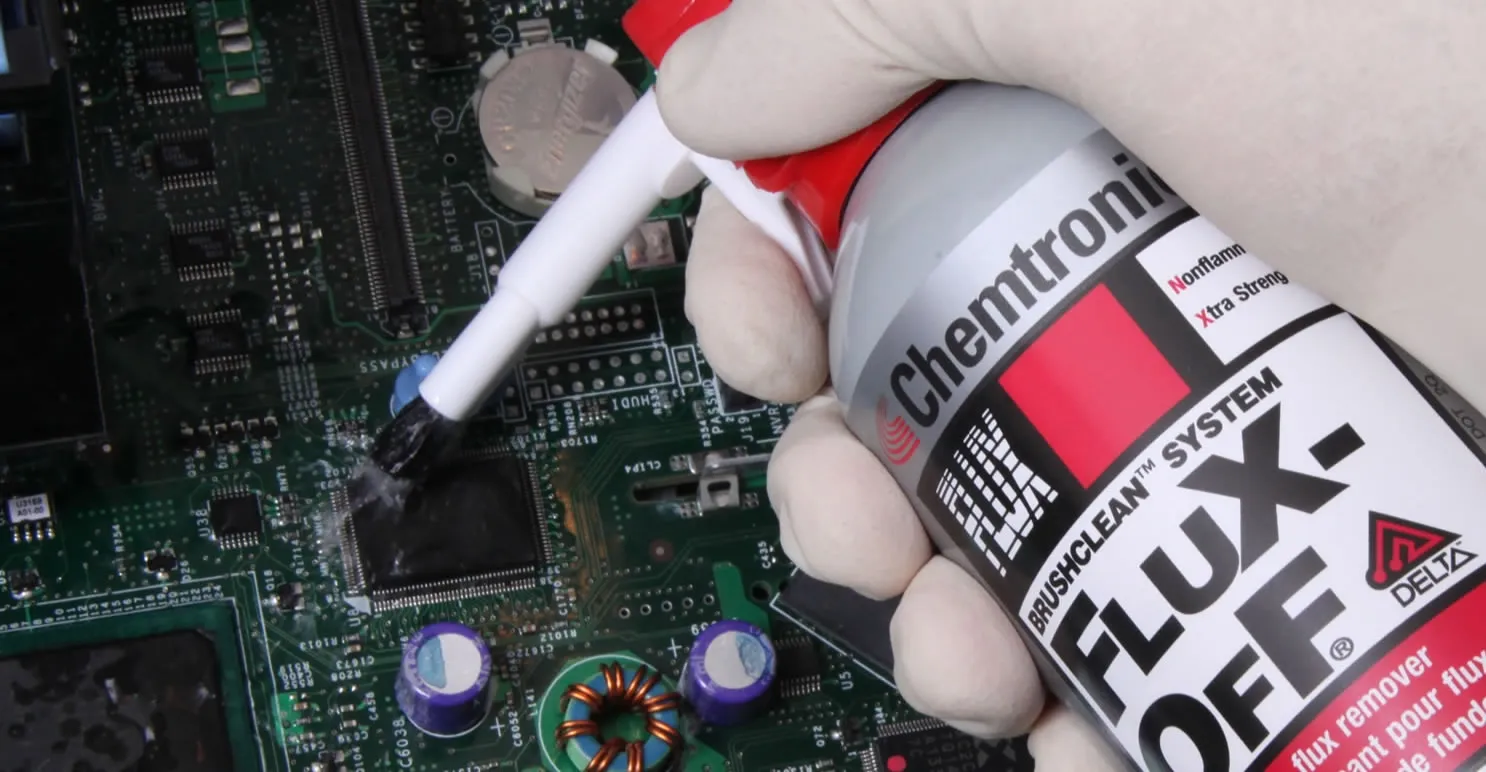 Cleaning wave solder pallets to remove flux residue.