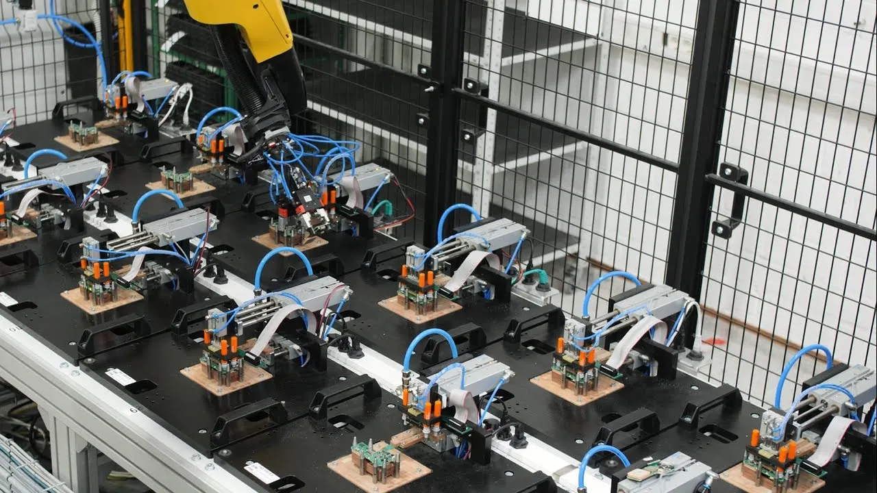 Electronics manufacturing team testing an automated rework system
