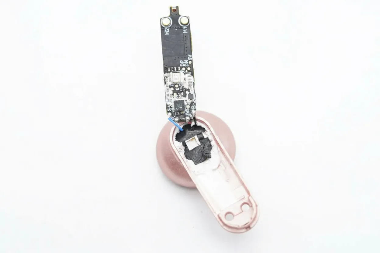 Mainboard unit inside cavity with microphone sealed by rubber cap