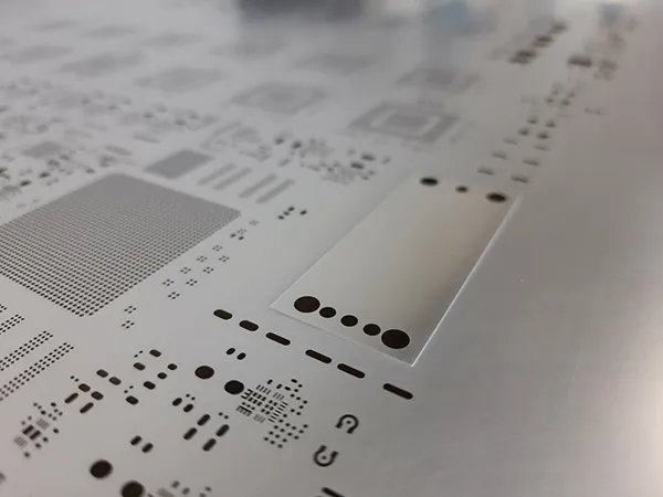 Step stencil for PCB assembly with varying thickness areas.