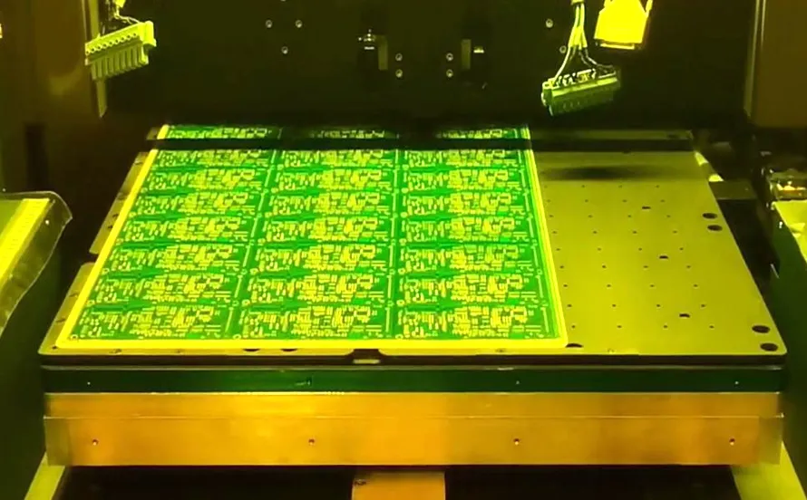 Vacuum lamination machine applying dry film solder mask to PCB.