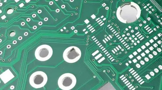 Finished PCB showcasing various drilled hole diameters for components and vias.