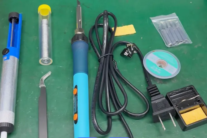 Organized soldering workstation for PCB assembly with essential tools.