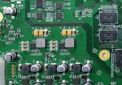 Close-up of PCB components including resistors and capacitors for design cost analysis