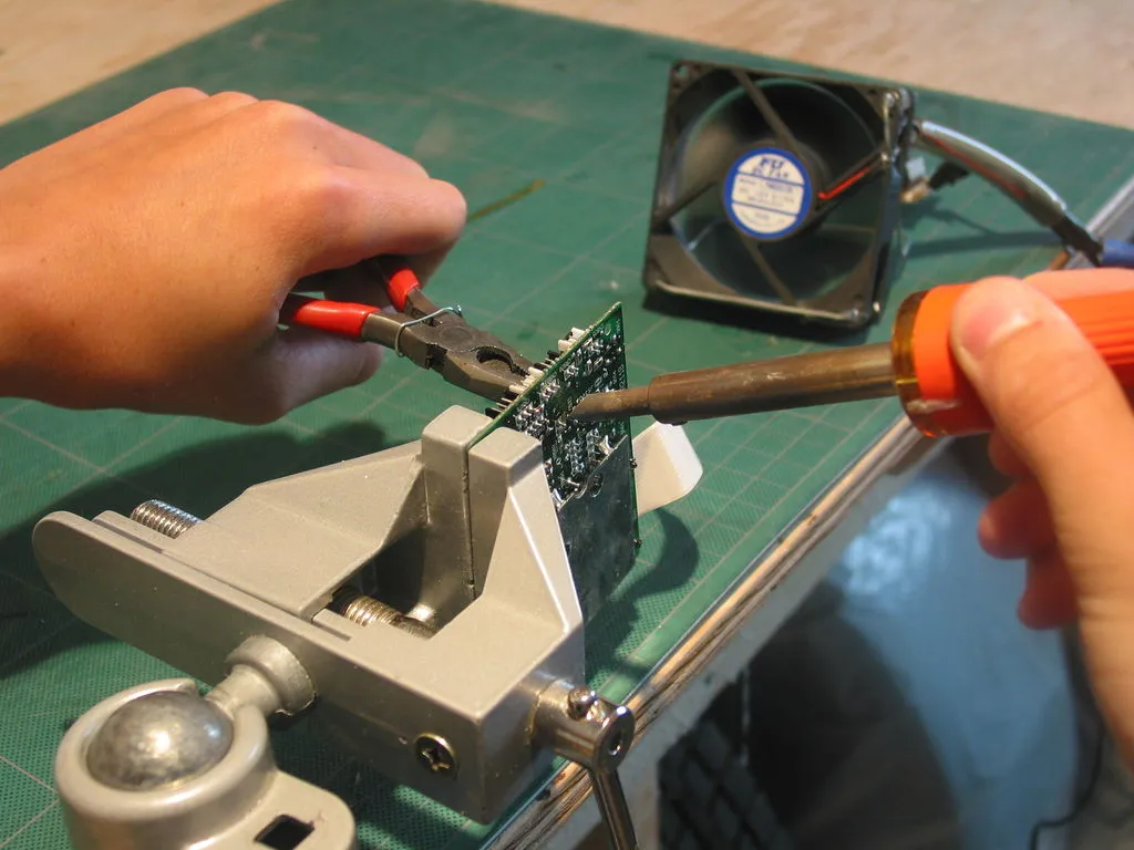 Hobbyist building eco-friendly PCB project with recycled parts.