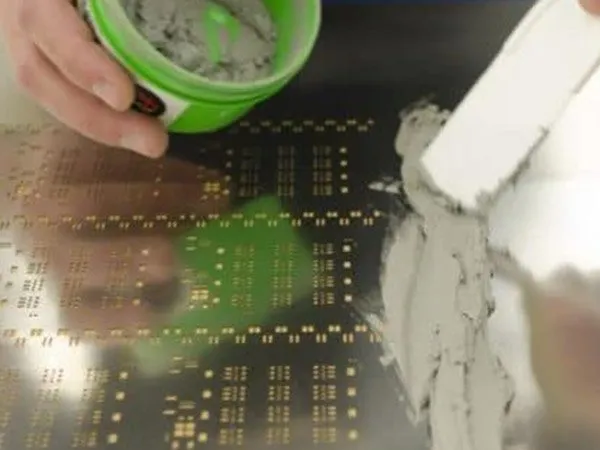 Stencil printer applying lead-free solder paste on PCB for SMT assembly.