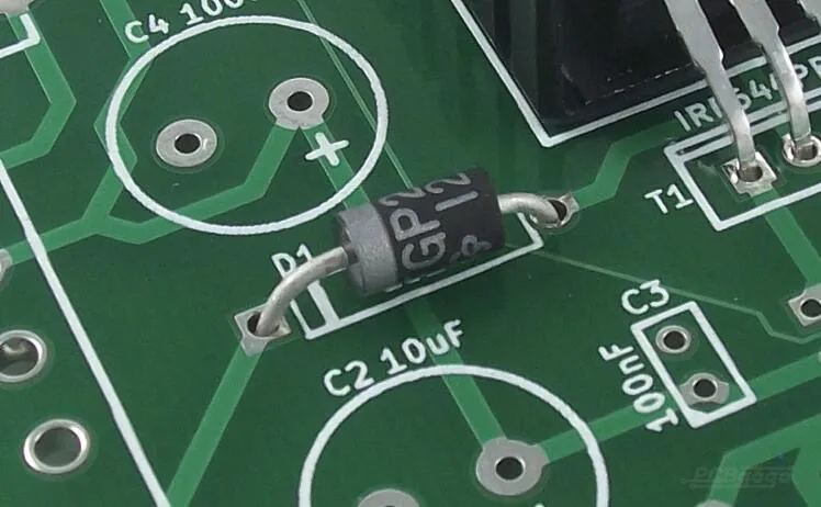 Close-up of PCB with clear silkscreen markings on a green solder mask for optimal readability.