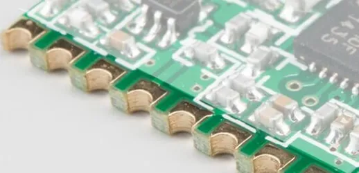 Close-up view of PCB with half-hole castellations plated for module interconnection
