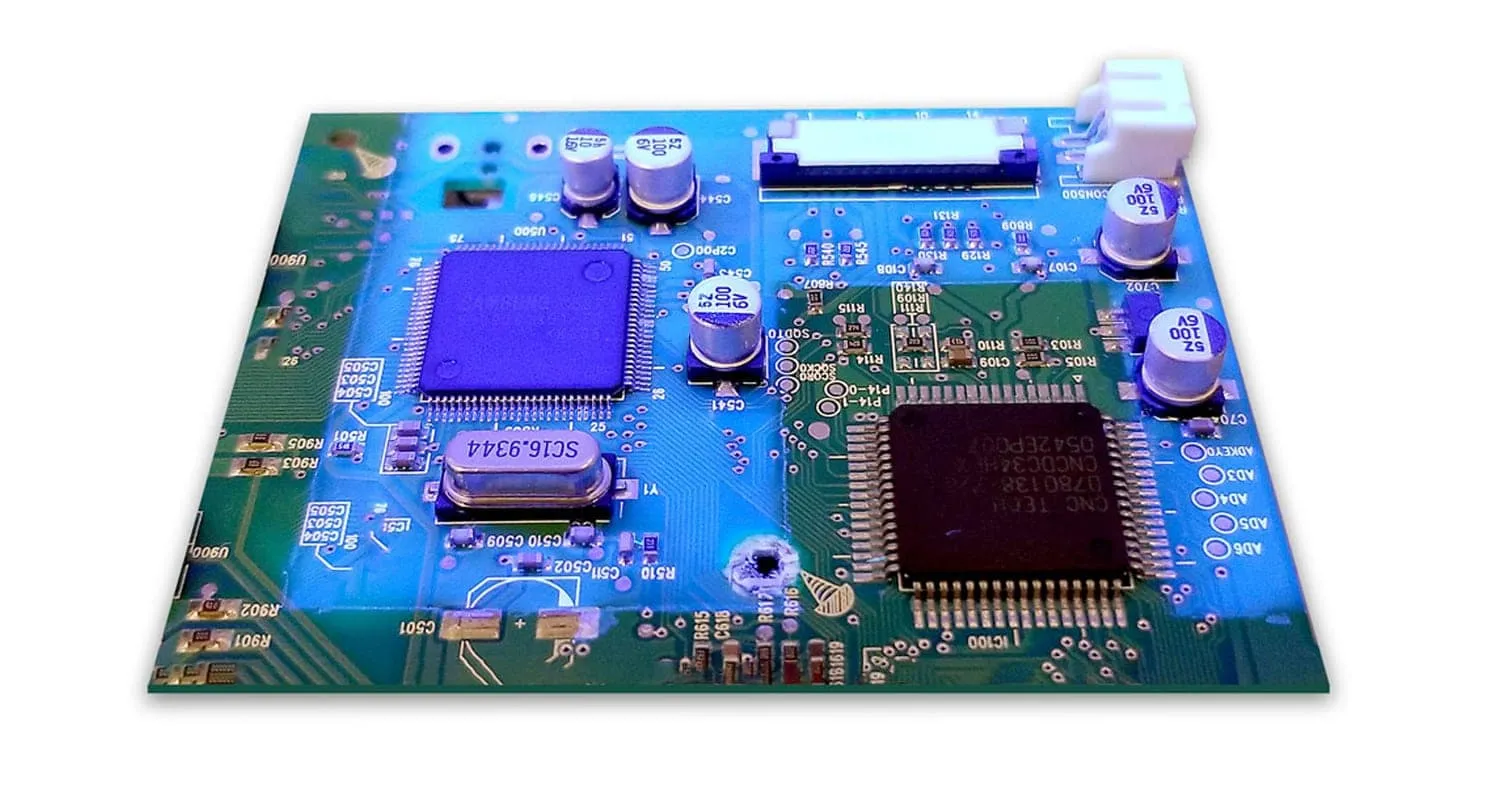 Close-up of a PCB with conformal coating for environmental protection.