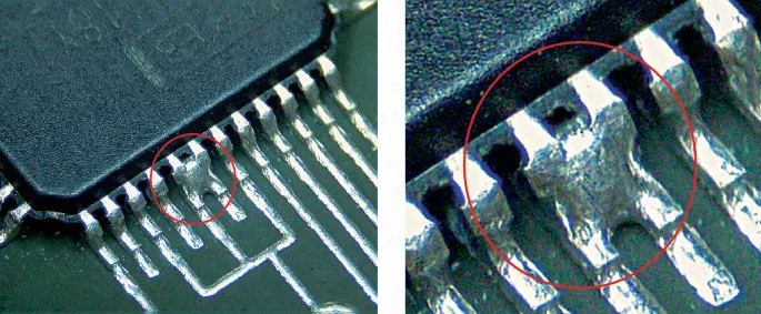 Solder bridging defect on SMT PCB assembly showing unintended connections.