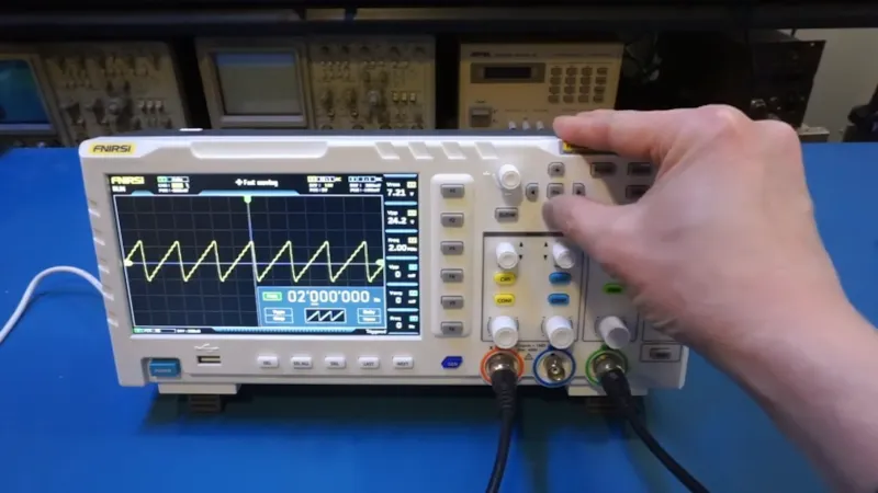 "Budget oscilloscope displaying a signal from a PCB for diagnostics."