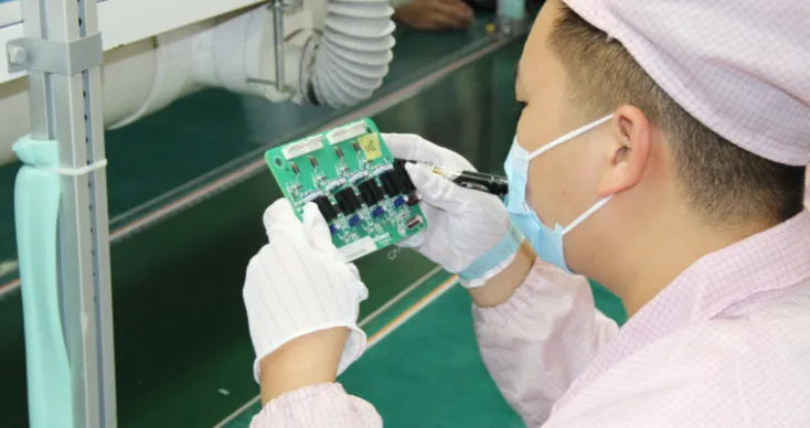 Technician performing step-by-step visual PCB inspection