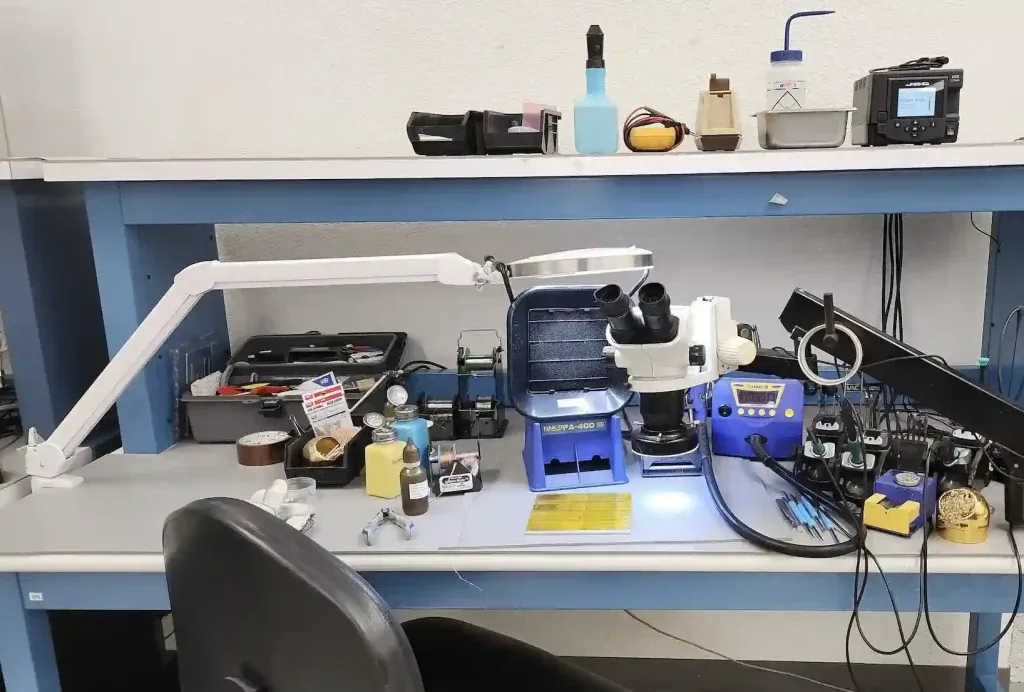 Workbench setup with essential tools for rigid-flex PCB repair