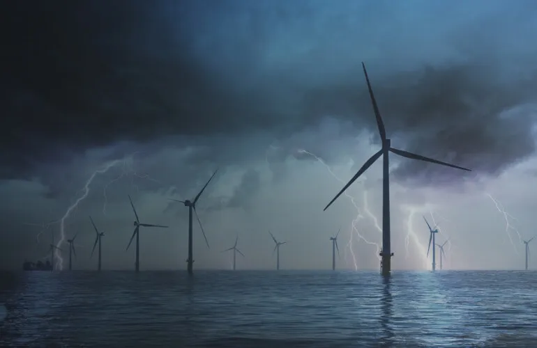 Offshore wind turbine in harsh weather conditions highlighting the need for durable PCB materials