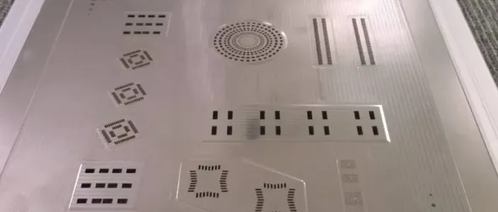 Close-up of an SMT stencil with precise laser-cut openings for solder paste application