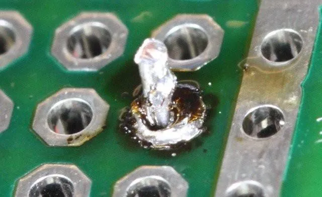 PCB with flux residue after rework before cleaning.