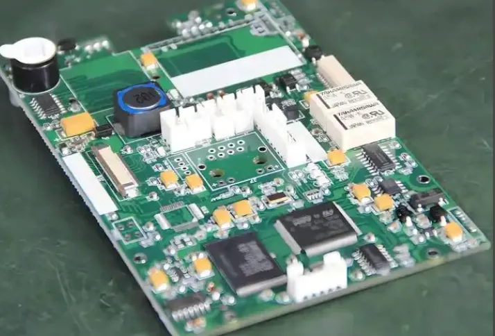 Applying masking tape for conformal coating masking techniques on a PCB.