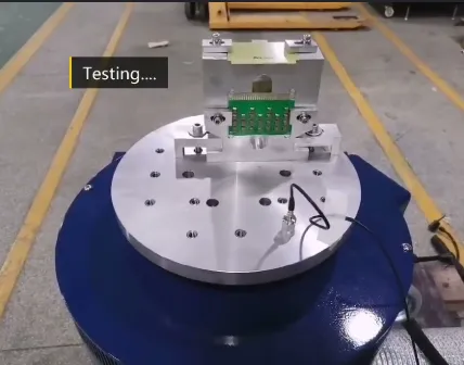 Aluminum PCB mounted on shaker table undergoing random vibration testing