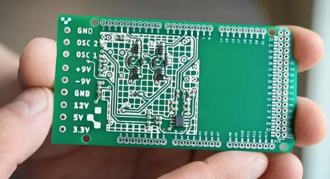 Close-up of PCB with white silkscreen markings for component identification.