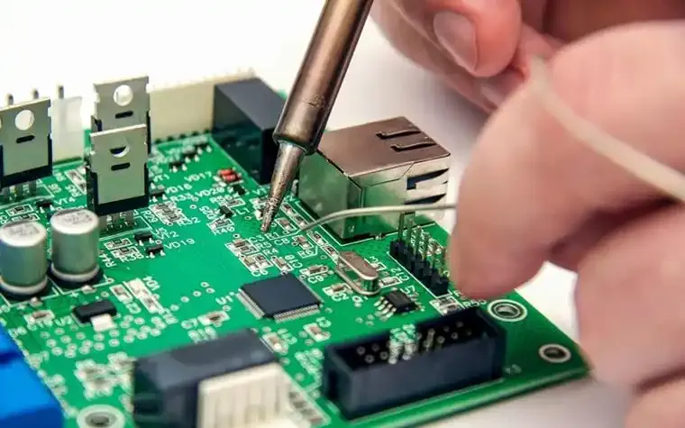 Professional technician performing vending machine PCB repair