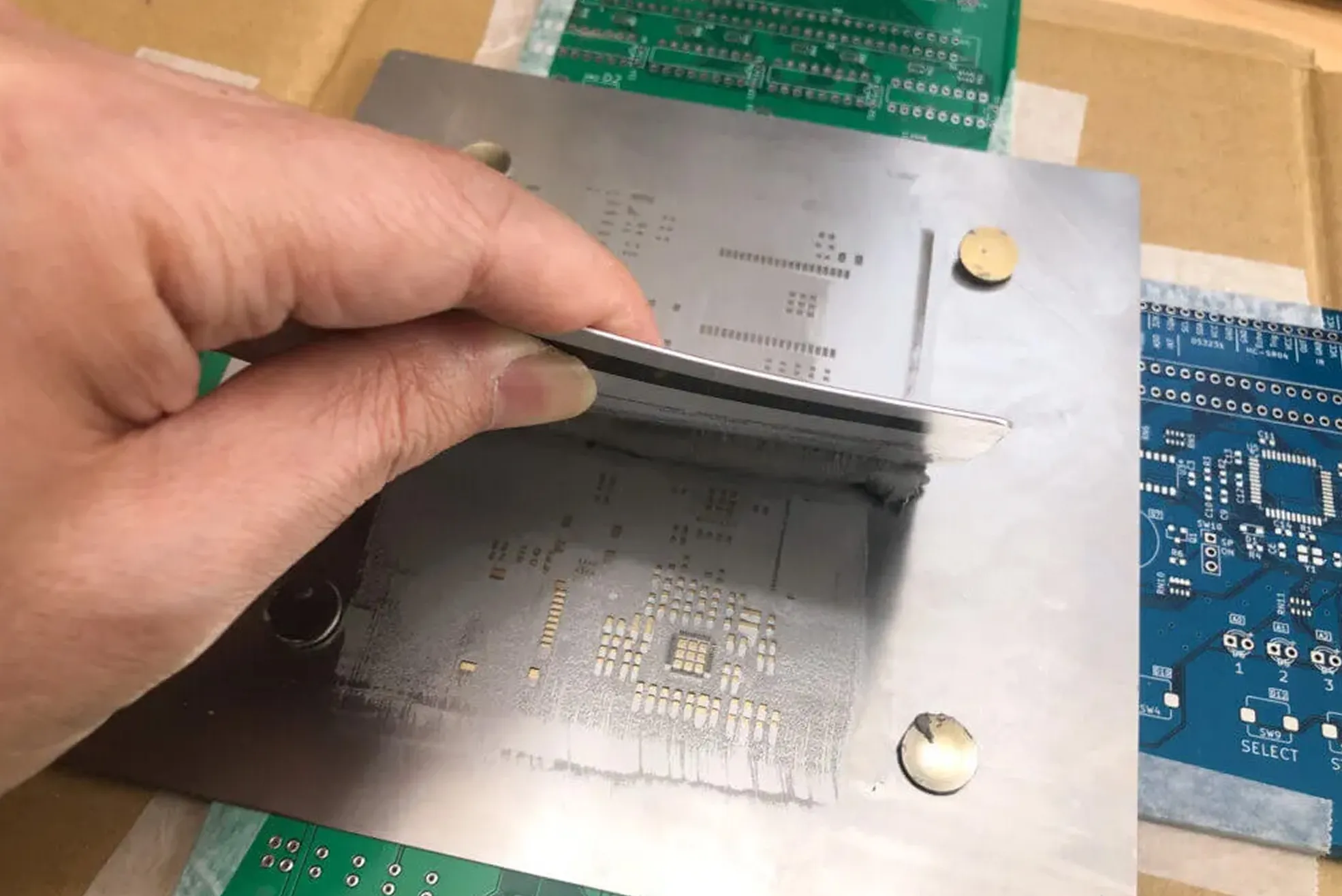 Applying solder paste with a squeegee for manual SMT assembly
