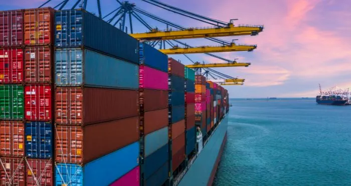 Cargo ship at port highlighting transportation delays in PCB logistics