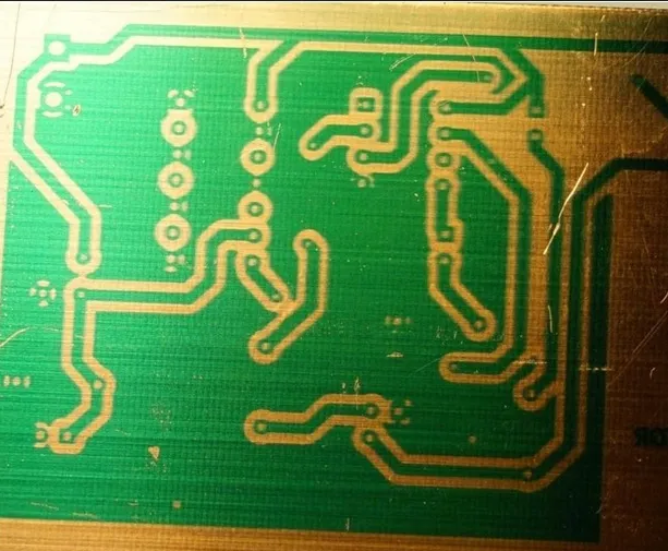 Close-up of PCB with uneven etching and residue defects"