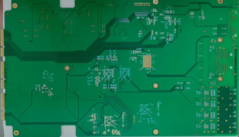 Close-up of a PCB with a green solder mask layer protecting copper traces