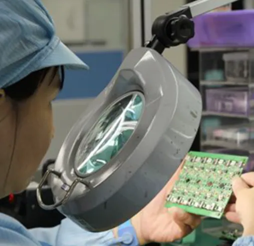 Manual visual inspection PCB by technician.