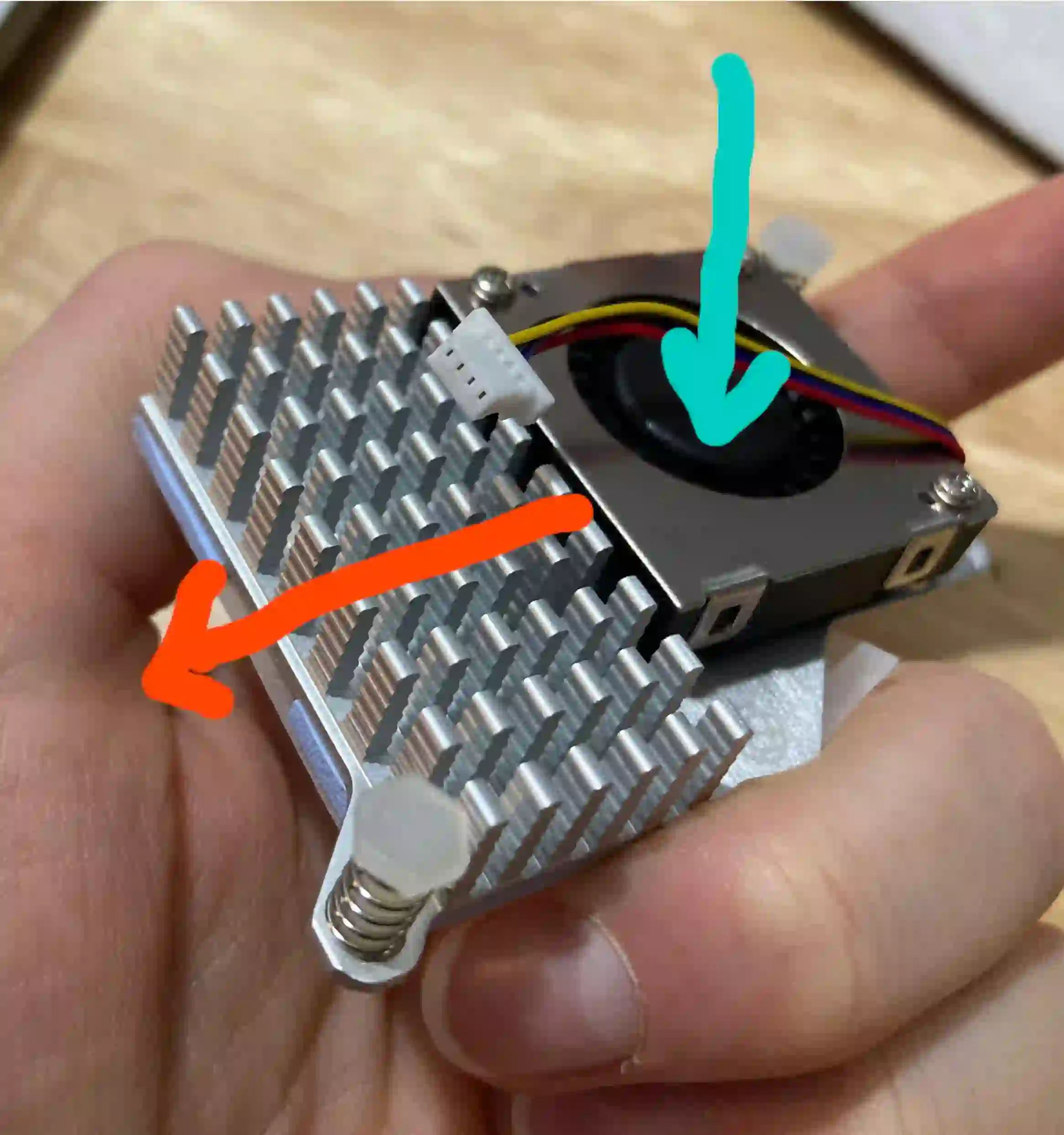 PCB with heat sink mounted on a component, showing fin orientation for airflow.