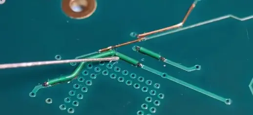 Soldering a small break in a PCB trace.
