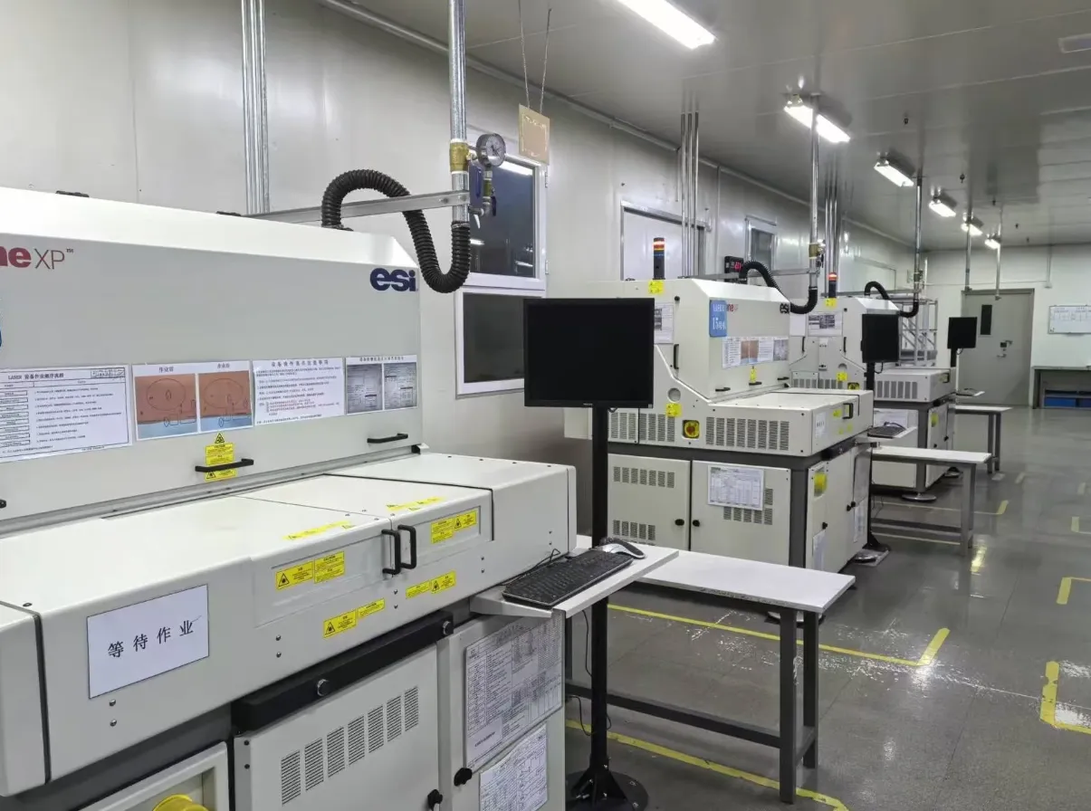 PCB manufacturing facility with safety signage for laser drilling areas.