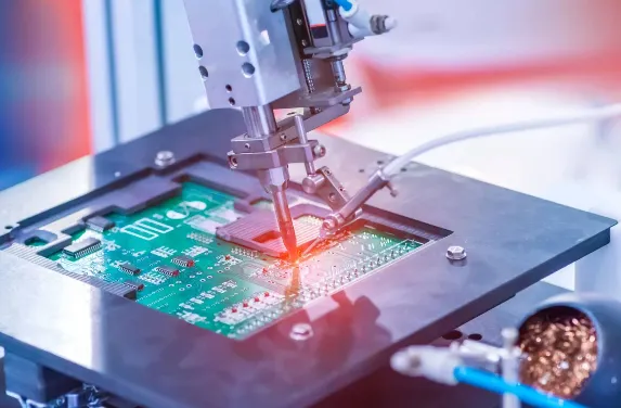 High-speed robotic pick and place machine assembling components on PCB