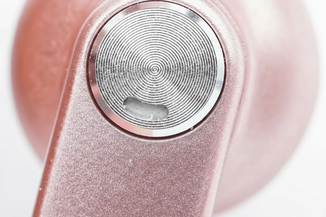 Earbuds exterior with runway-style stem and silver touch disc